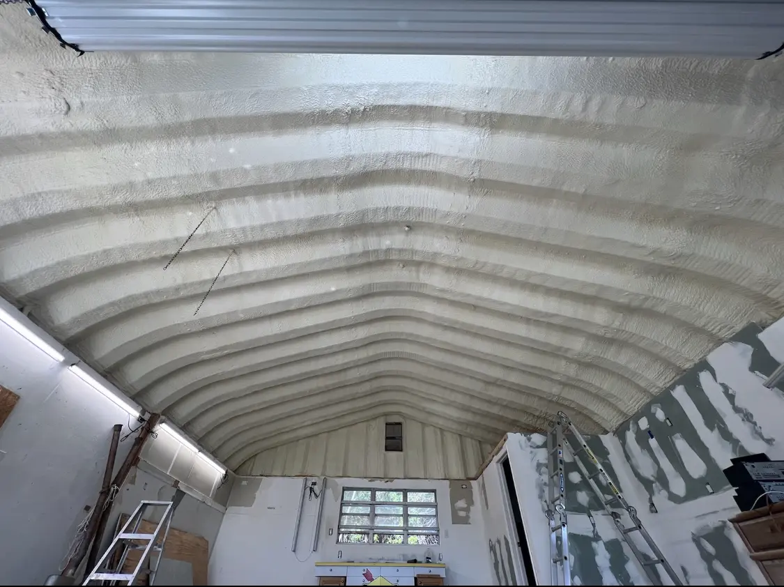 Spray polyurethane foam applied to the underside of a metal roof deck in Evansville